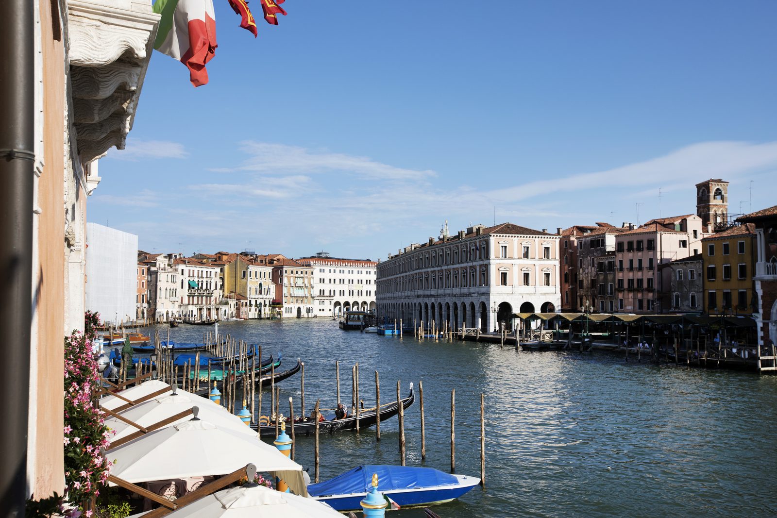 The Grand Canal at civil twilight, with the Italian flag and Venetian flag of the winged lion in the foreground